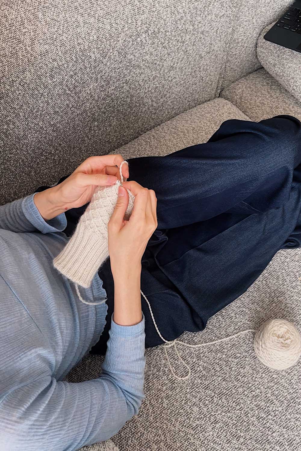 knitpicks-woodland-yarn-being-knit-into-a-cabled-sweater